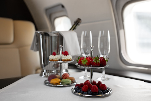 Business jet plane interior with leather comfortable seats. Private airplane transfer
