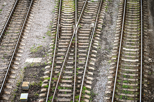 Railroad tracks in heavy rain, water reflections abstract. Wet train tracks, water on railway closeup, detail. Sad, melanholic view, nobody. Relaxation background, relaxing rain, calm, serene scene