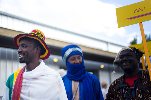 Santa Fe, NM: Smiling African artists (from Ethiopia and Mali) in traditional dress at the Folk Art procession at the Santa Fe Railyard plaza. The procession kicks off the annual International Folk Art Market (IFAM), where folk artists from over 50 countries and tribes participate.