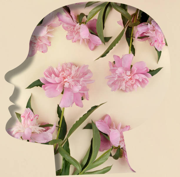 istock Human head silhouette, pink peonies in the middle 1528950253