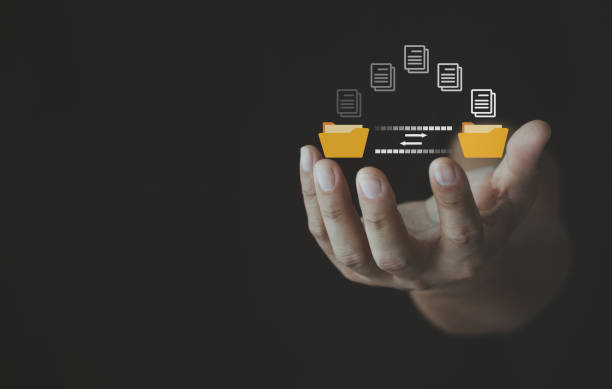 istock Man hand transferring files in virtual screen for Send of document on internet. Data transfer, Transfer file of data between folder, Backup data, Exchange of file on folder, DMS. Virtual document. 1529001974