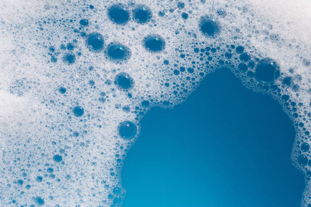 istock Detergent foam bubble on water. Blue background, Soap sud 1529048527
