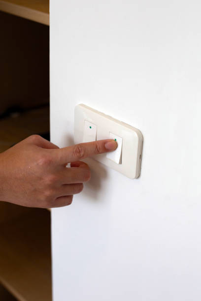 istock Male finger is turn off on lighting switch in room 1529055738