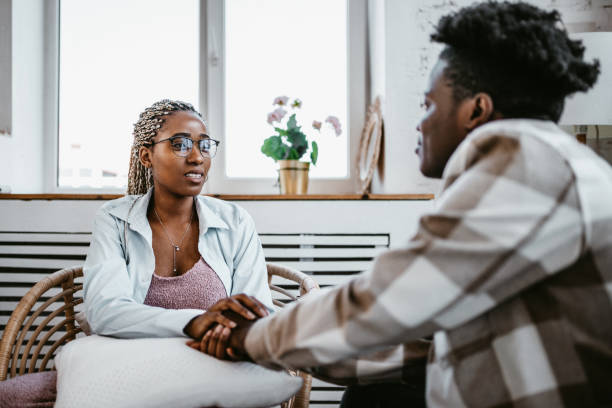 istock Two young people holding hands, showing support and care 1529128408
