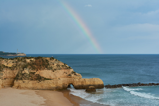Rainbow over the Atlantic Ocean. Portimao, Algarve coastline, Portugal