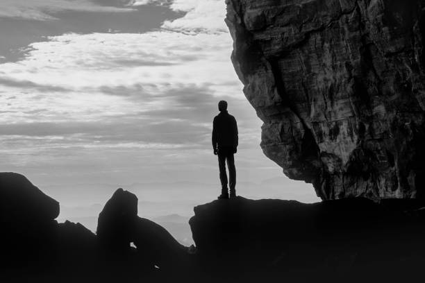 istock Man standing on a rock contemplating the scenery 1529279922