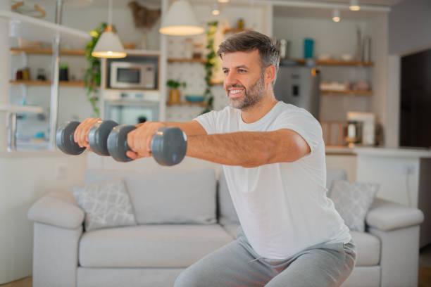 istock Man at home keeping fit by exercising 1529320505
