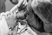 Mother holding her newborn baby child after labor in a hospital