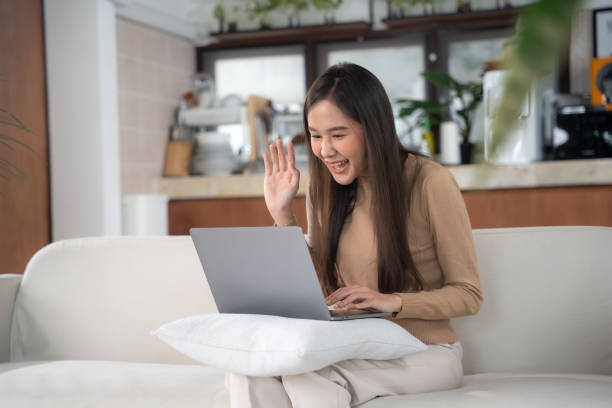 istock Beautiful young asian woman using laptop at hame. 1529370104