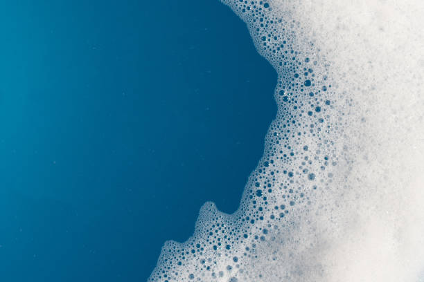 istock Detergent foam bubble on water. Blue background, Soap sud 1529378077