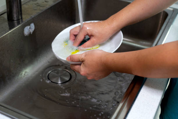 istock Man washing dish on sink in kitchen room 1529383252