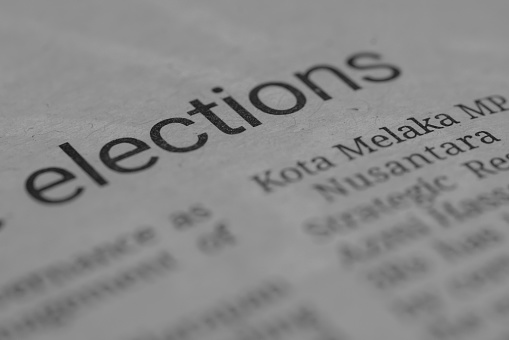 The close-up view showcases the word 'elections' on a newspaper