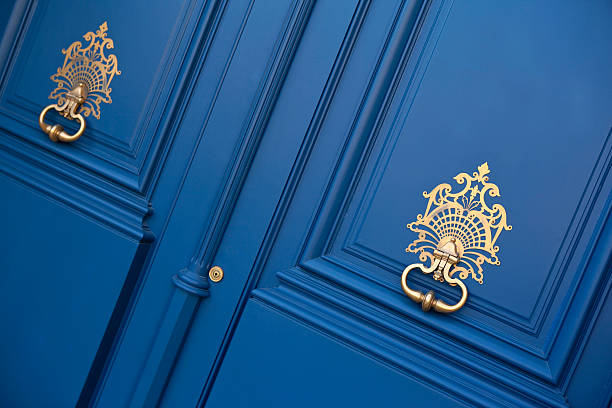 Double doors Double doors with knockers at the entrance of a mansion in Bordeaux, France blue front door stock pictures, royalty-free photos & images