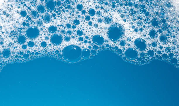 istock Detergent foam bubble on water. Blue background, Soap sud 1529393187