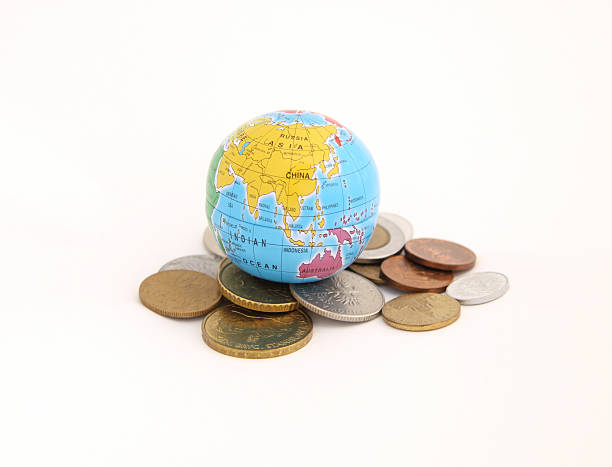 istock globus lying on a pile of coins 152939371