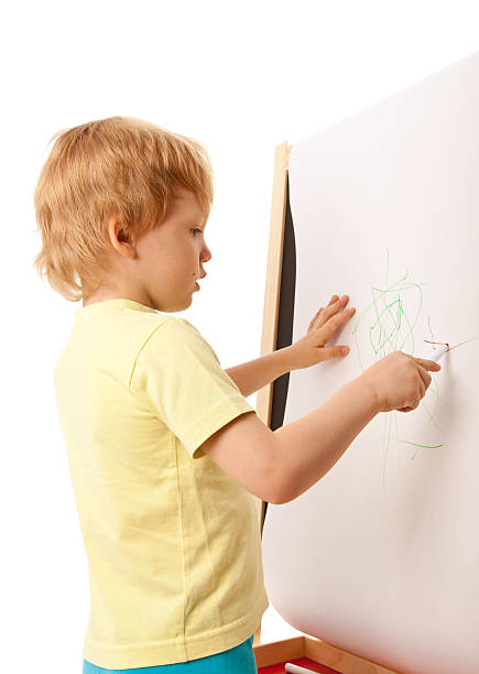 istock Four-year old boy drawing picture on easel 152941156