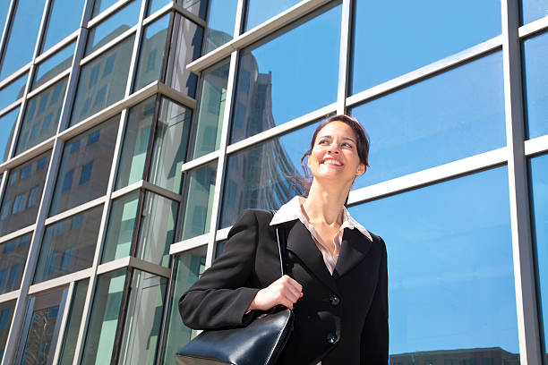 istock Happy businesswoman walking downtown 152942594