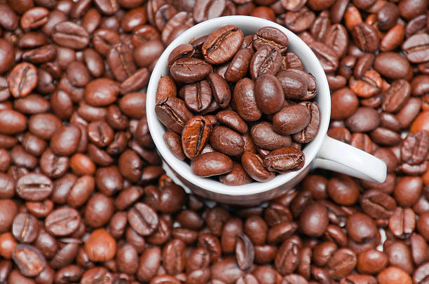 Closeup of cup filled with coffeee beans stock photo