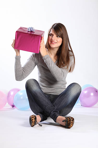 istock Beautiful young girl curious about birthday gift 152943924