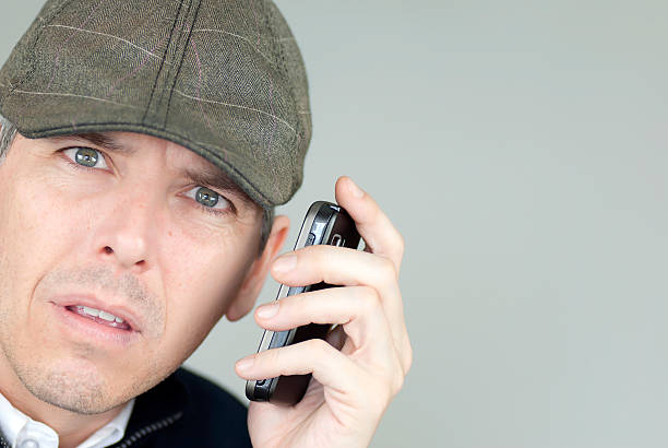 istock Stressed Man In Newsboy Hat On Phone 152944536