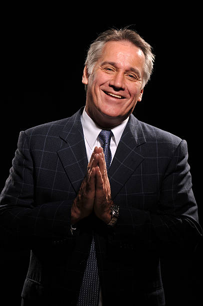 istock Happy handsome man praying wearing a suit 152945302