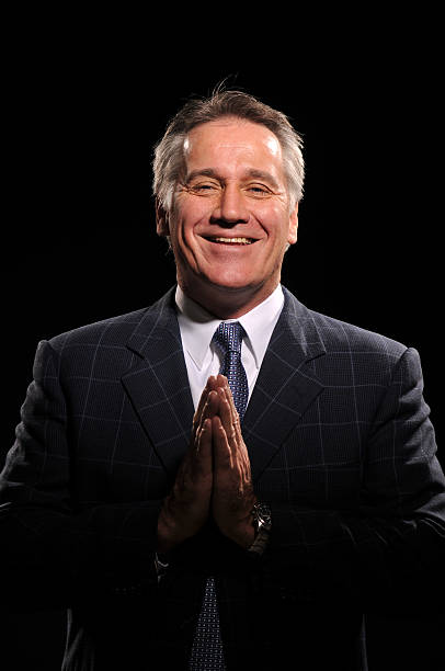 istock Happy handsome businessman praying wearing a suit 152945397