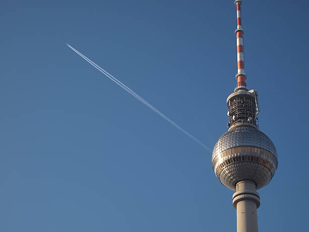 Berlin Tv Tower and airplane in the sky stock photo