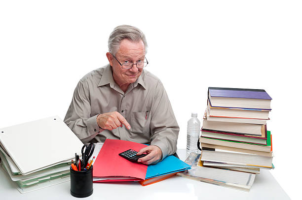 istock Businessman Sitting at Desk While Smiling and Pointing to Calculator 152945727