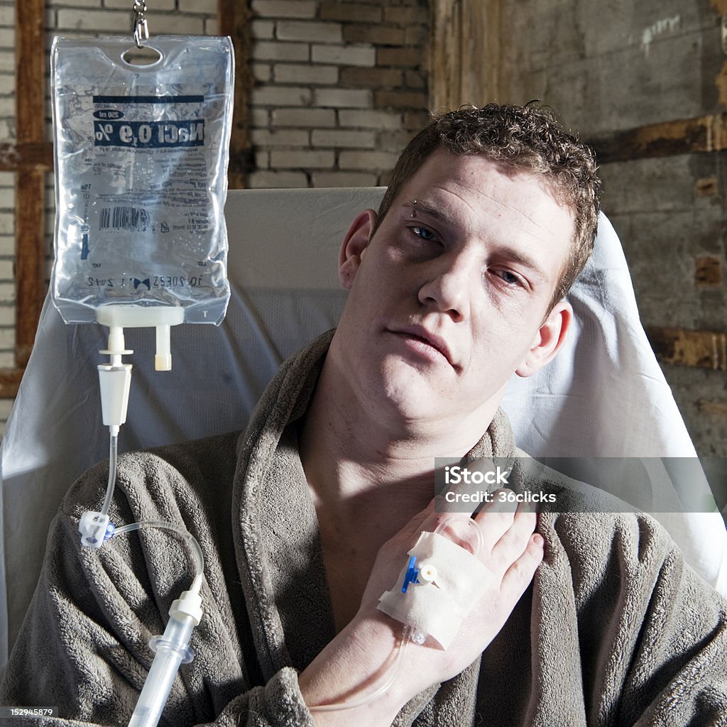 Sick man Very sick man, with an IV drip sitting in a chair 20-29 Years Stock Photo