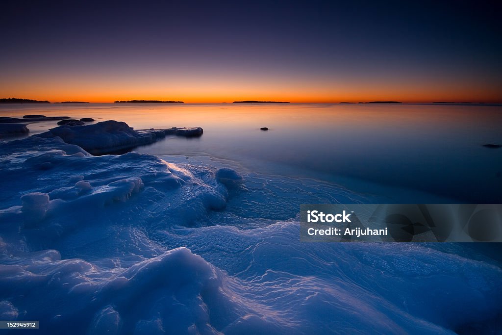 Sunrise on icy beach Morning dawn in the icy beach. Arctic Stock Photo