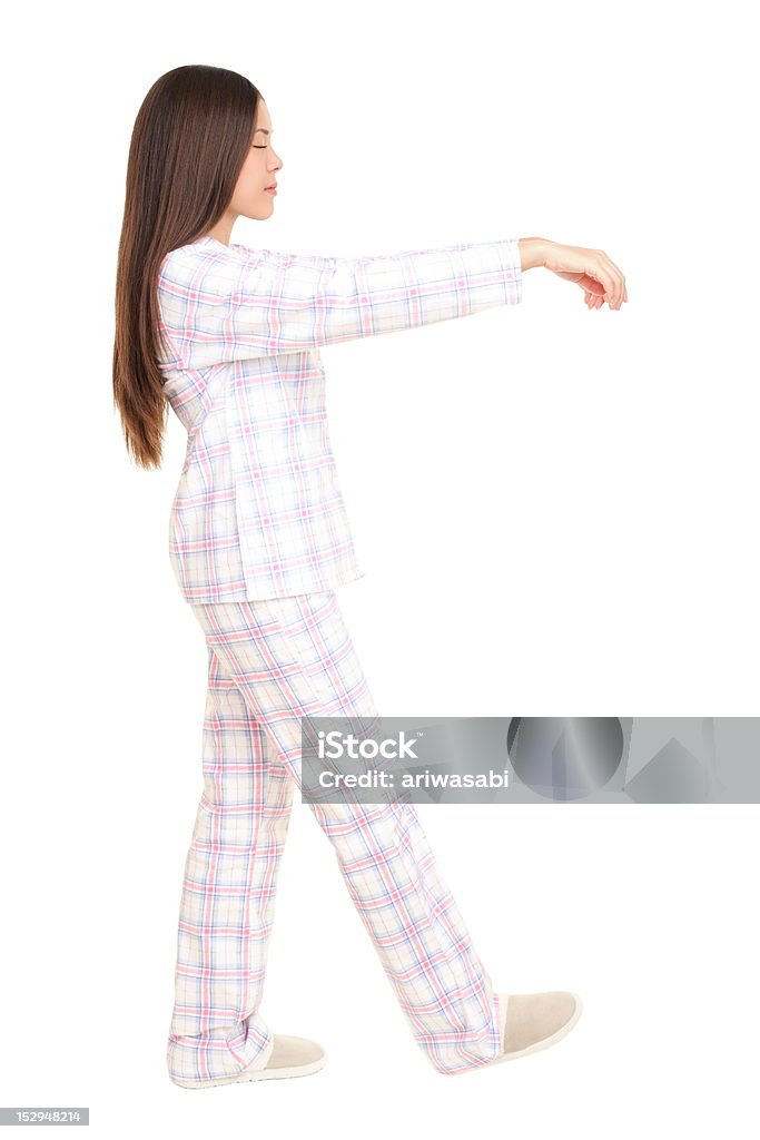 Sleeping sleepwalking woman Sleepwalking woman isolated on white background. Profile view of young woman walking in her sleeps in pajamas with arms raised. Full length image- Sleepwalking Stock Photo