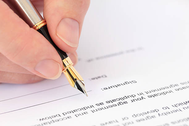istock Hand with Fountain Pen Signing a Document 152948973