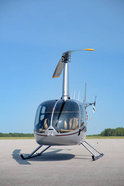 istock Small Helicopter Parked on a Helipad 1529496485