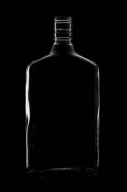 istock Rum bottle silhouette against black 152950444