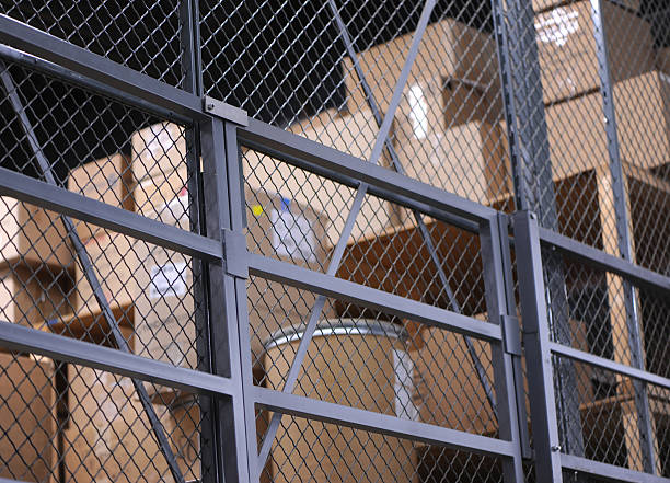 Storage cage with several carton boxes in shelfs stock photo