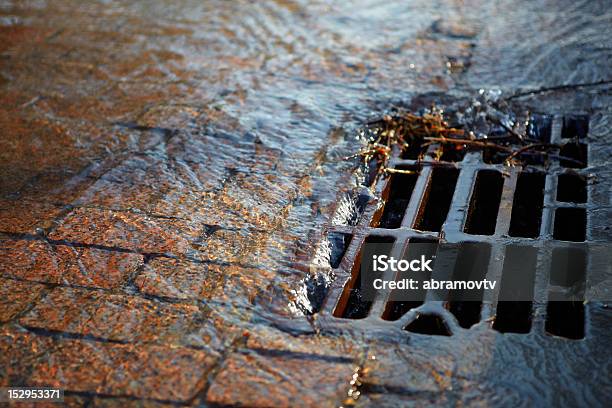 Water Flows Into The Hatch On A Spring Sunny Day Stock Photo - Download Image Now - Sewer, Manhole, Sewage