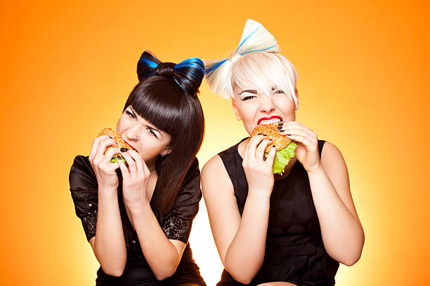 two girls with burgers