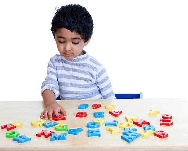 istock Preschooler Identifying Alphabets and Numbers, Isolated, White 152954157