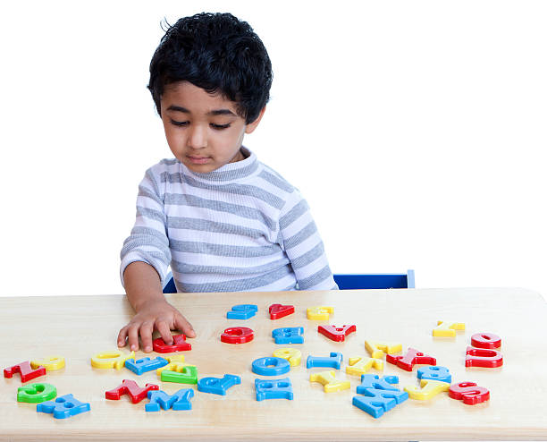 Preschooler Identifying Alphabets and Numbers, Isolated, White stock photo