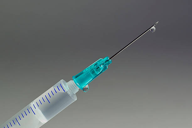 istock Droplet on the Point of Hypodermic Needle 152954252