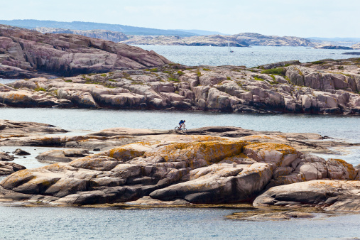 Cyclist on the rocks in the sea islands