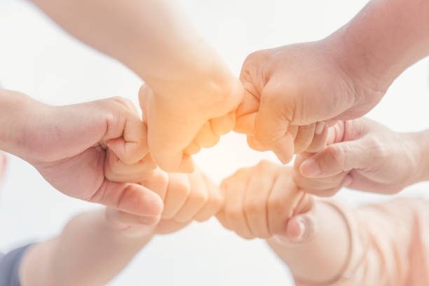 istock Close up hands Diverse multiethnic Partners team together. Teamwork group of multi racial people meeting join hands. Diversity people hands join empower partnership teams connect volunteer community 1529547889