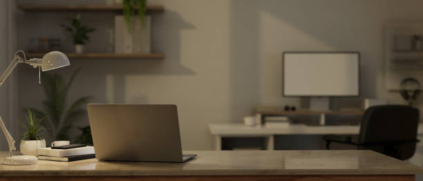 istock Close-up image of a laptop computer and accessories on a tabletop in a modern office room. 1529551985
