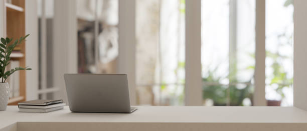 istock A modern workspace with a laptop on a tabletop against a blurred, bright room in the background. 1529551986