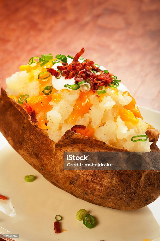 Loaded Baked Potato Baked potato loaded with cheese, green onion, sour cream, and bacon Bacon Stock Photo