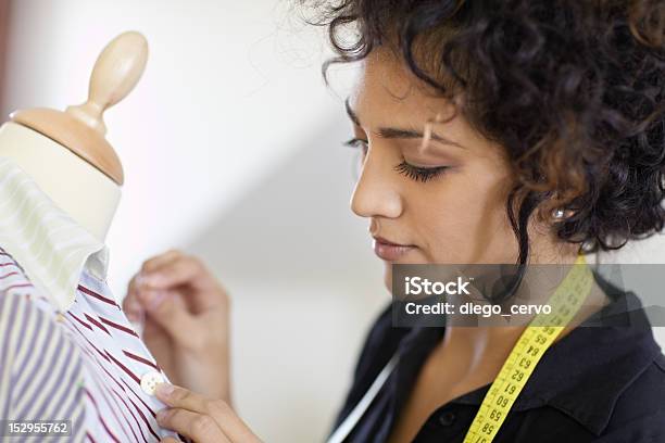 Curly Haired Woman Working In A Fashion Design Studio Stock Photo - Download Image Now