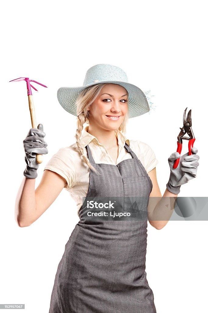 Young female gardener with a gardening tools A young female gardener with a gardening tools isolated on white background Adult Stock Photo