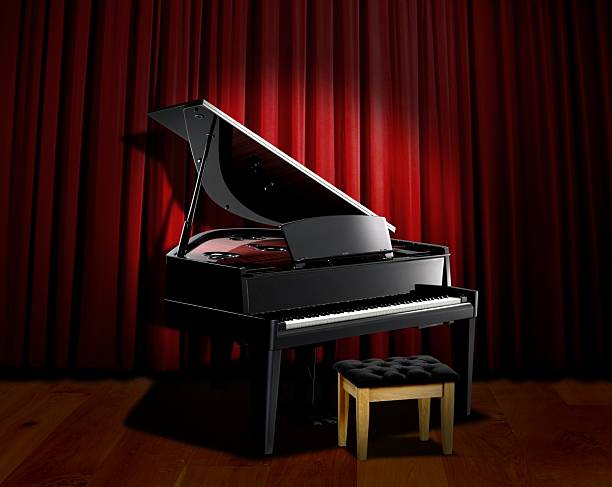 istock piano spotlight with red curtain 152957357