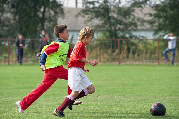 istock boy kicking football 152957401