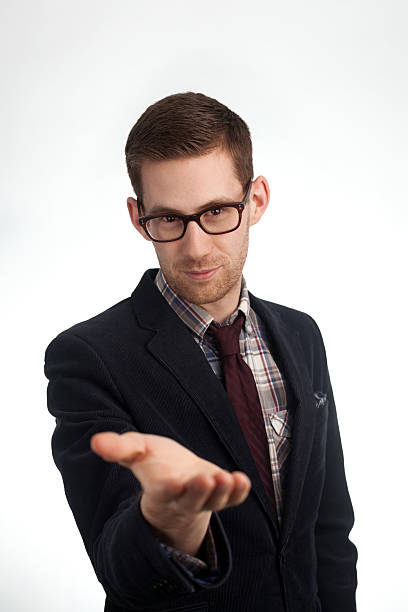 Young man holding out hand with an inviting gesture stock photo